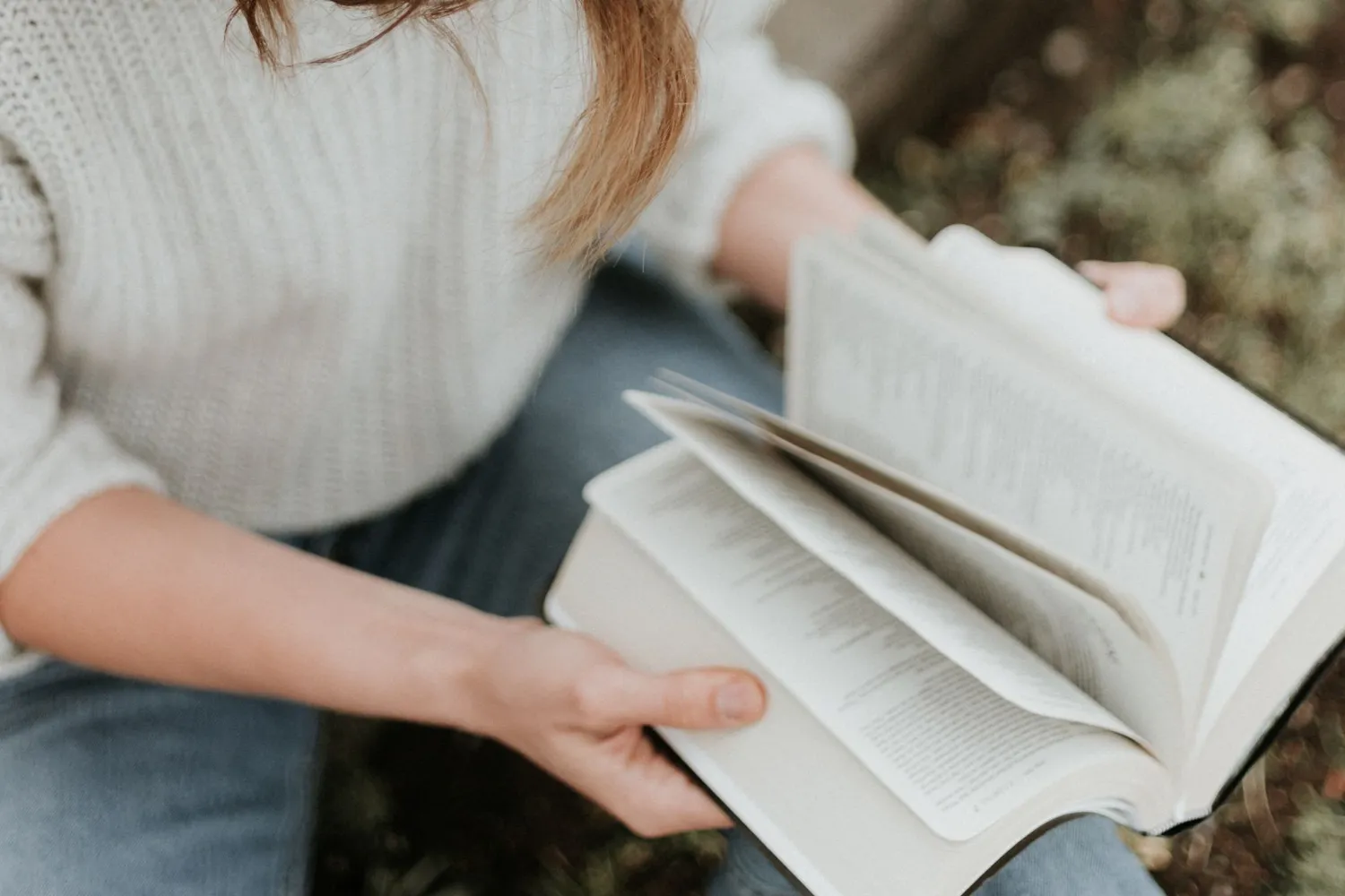 Unas manos sostienen una Biblia abierta.